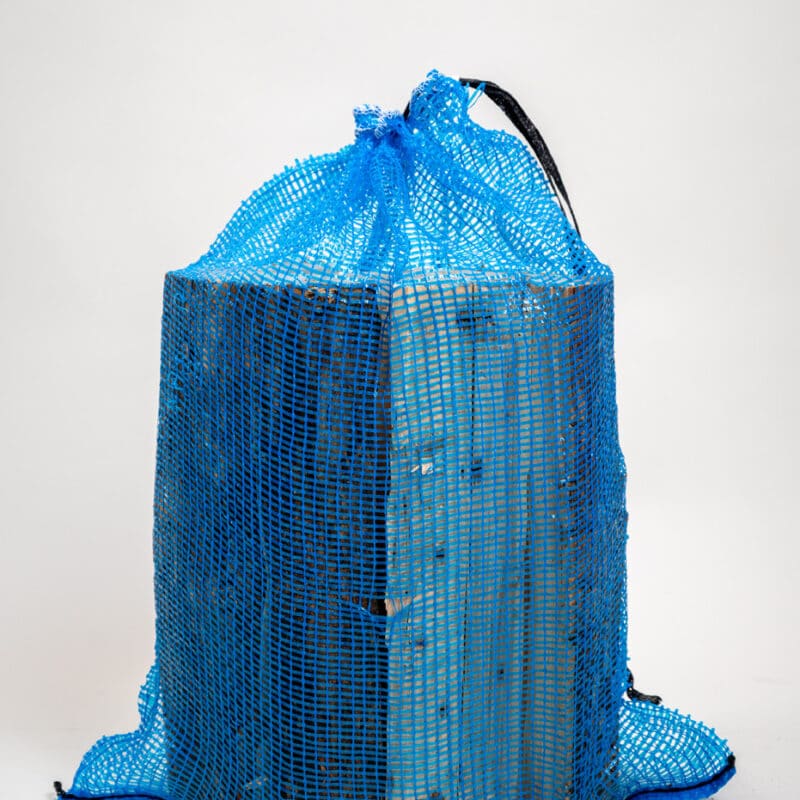 A blue bag with a handle resting on a white background.