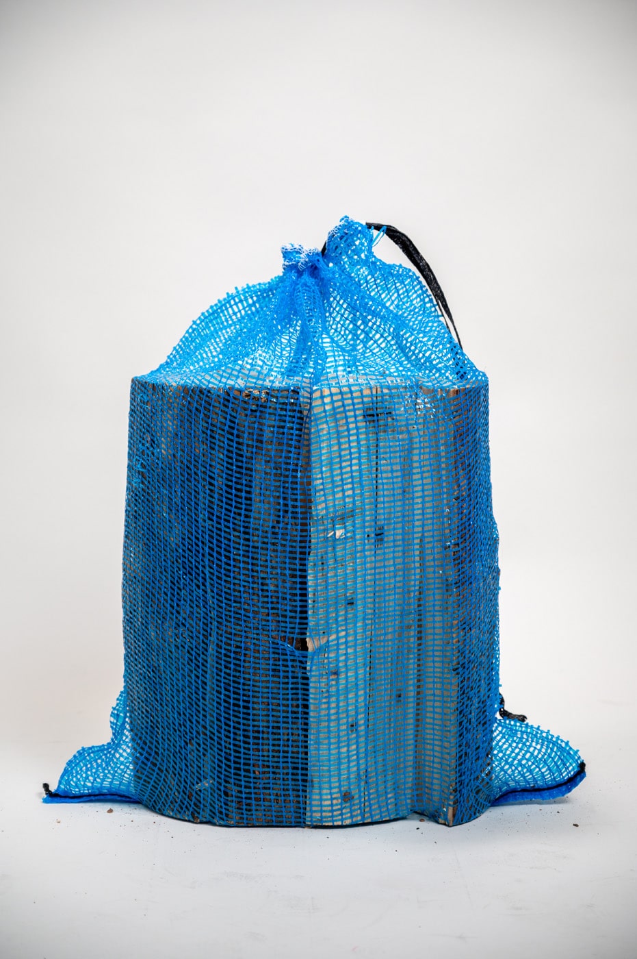 A blue bag with a handle resting on a white background.