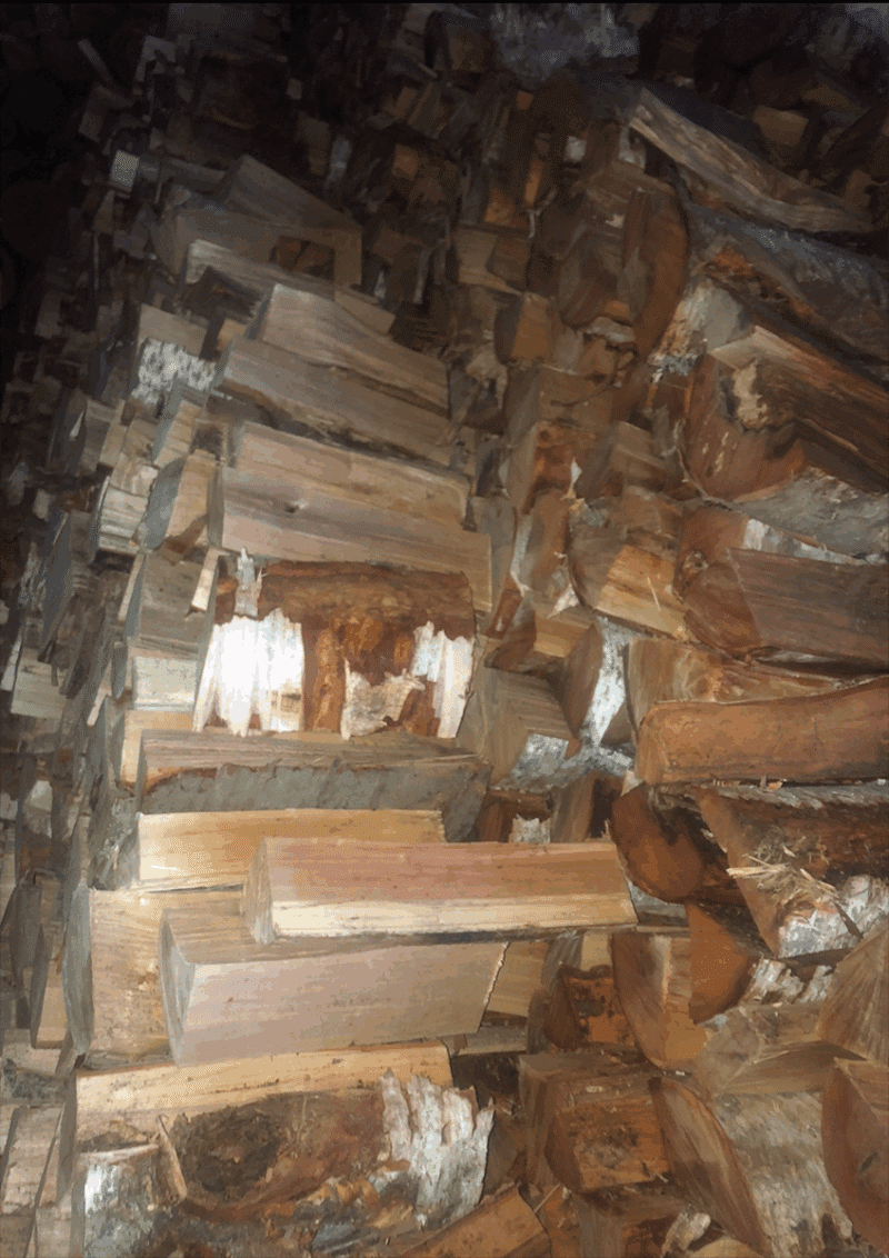 Cord of birch firewood stacked neatly, available for purchase 24/7, showcasing its natural texture and color.