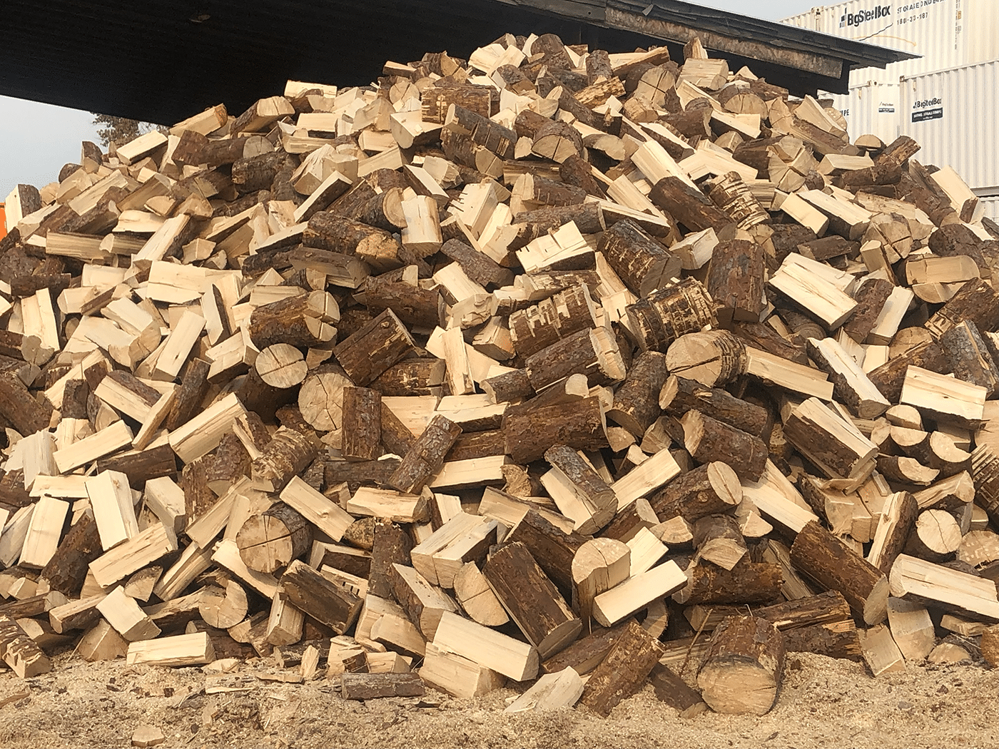 Cord of pine firewood stacked neatly, available for purchase 24/7, showcasing its natural texture and color.