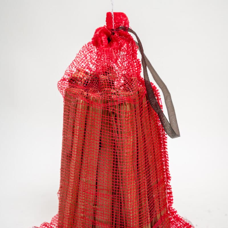 A red bag of firewood sticks displayed on a white background, labeled "Firewood 24/7."