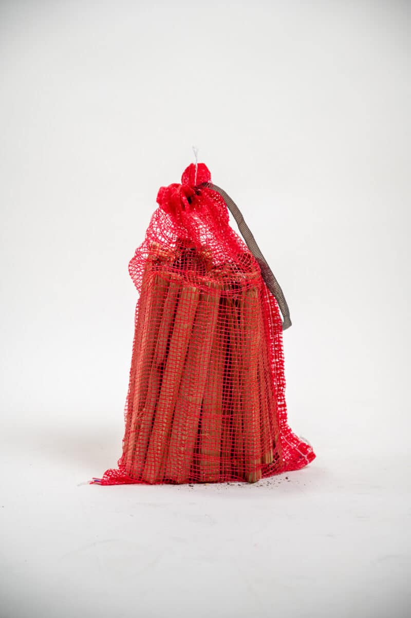 A wide red bag of firewood sticks on a white background, labeled "Firewood 24/7."