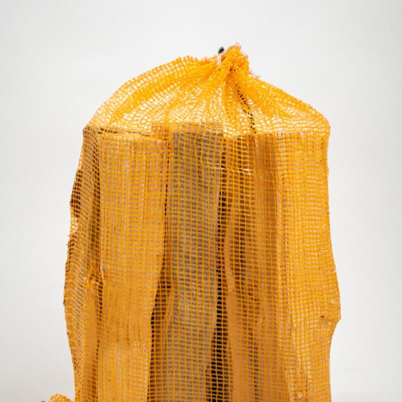 A yellow mesh bag filled with firewood, labeled "Firewood 24/7 - Yellow Bag Full."